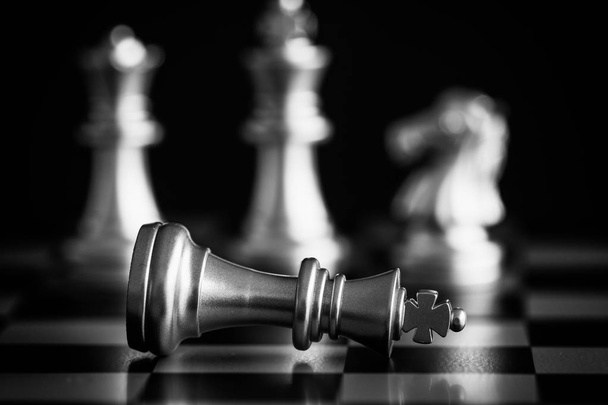 The King in battle chess game stand on chessboard with black iso - Foto, Bild