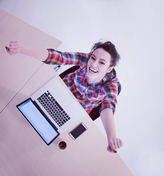 top view of young business woman working on laptop computer in modern office interior - Foto, imagen