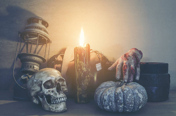 Halloween pumpkin head jack lantern and human skull on wooden background - Фото, зображення