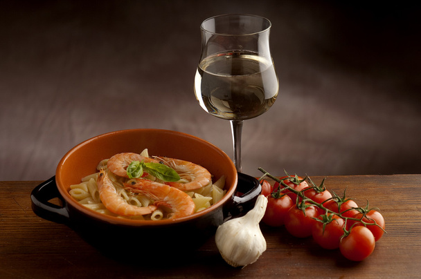 Pasta with shrimp and glass of wine - Фото, изображение