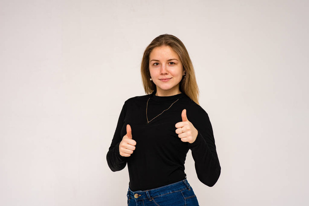 Beautiful girl in different poses shows different emotions on different backgrounds in different clothes - Фото, изображение