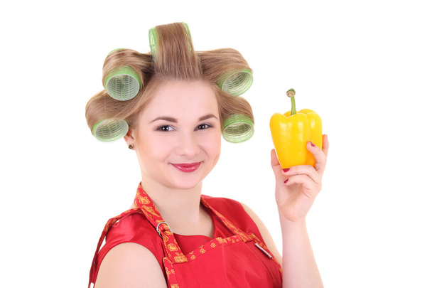 young housewife with hair curlers and yellow pepper - Photo, Image