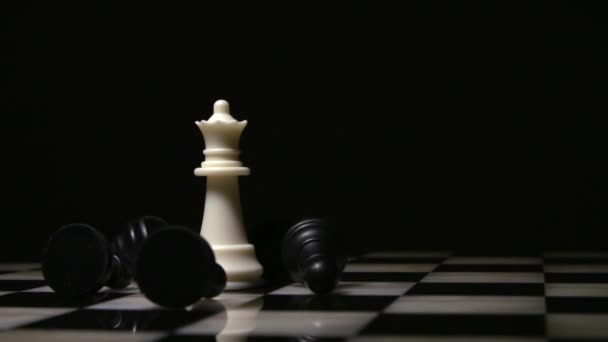 white queen surrounded by fallen black pawns - Footage, Video