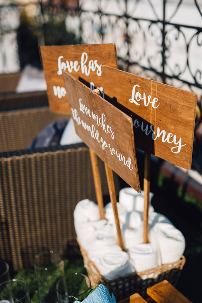 Wooden tables with funny letterings standing in box as wedding decor - Photo, Image