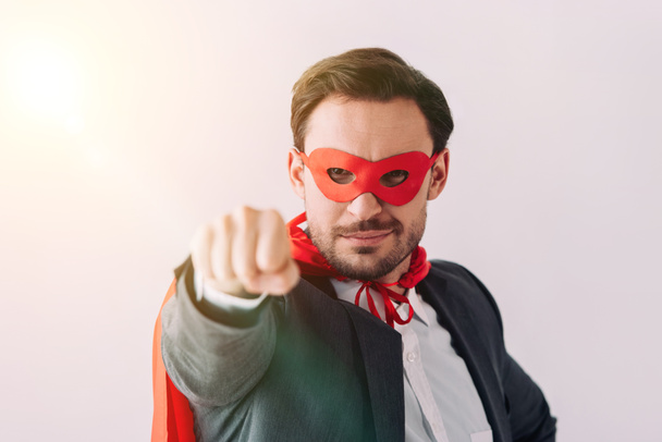 handsome super businessman in mask and cape showing fist isolated on white - Valokuva, kuva