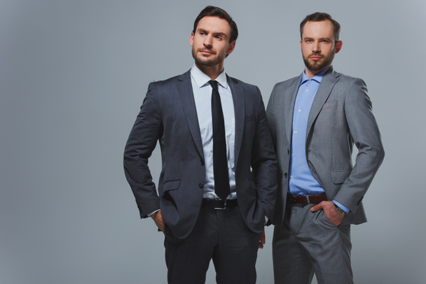 serious handsome businessmen isolated on grey - Фото, зображення