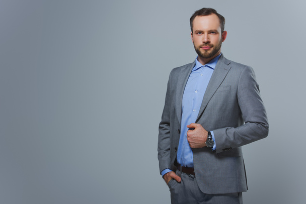 handsome businessman looking at camera isolated on grey - Photo, Image