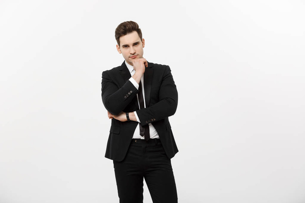 Young handsome man in black suit and glasses looking at copy-space smiling,thinking or dreaming isolated over white background - Foto, Bild
