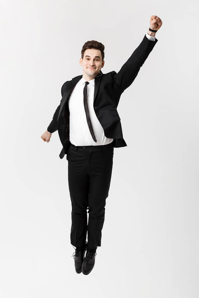 Business Concept: Excited businessman celebration success. Isolated on white studio background - Foto, afbeelding