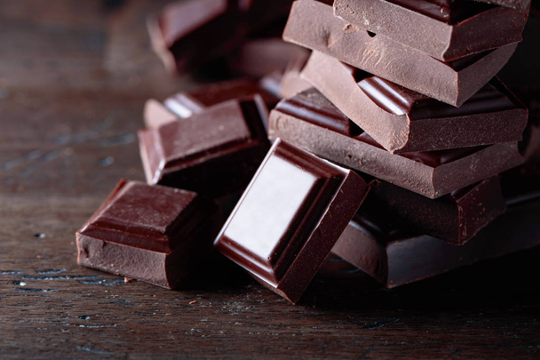 Broken black chocolate pieces. - Photo, Image