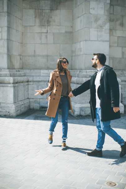 Walk of the pretty loving couple happily walking and holding hands in Budapest, Hungary - 写真・画像