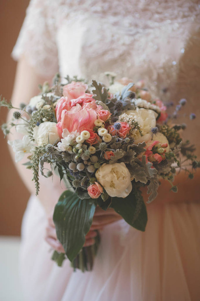 Bride holding fresh wedding bouquet with roses and dried flowers - Photo, Image