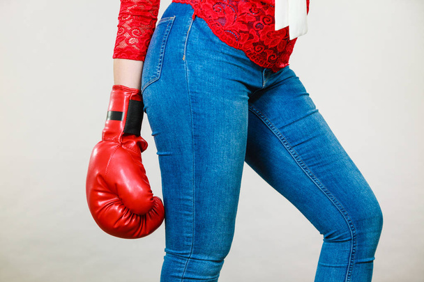 Woman wearing boxing glove - Foto, Imagen