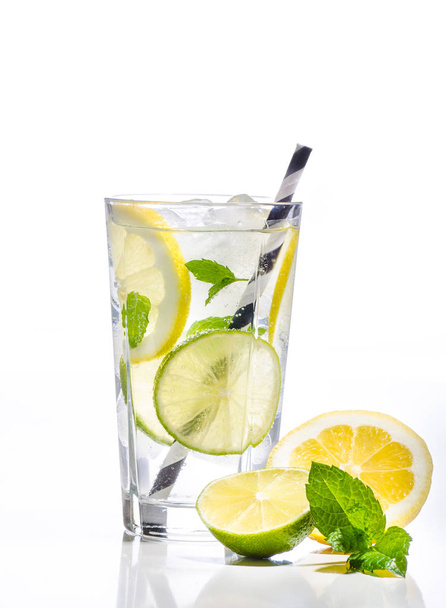 Glass of lemonade with lemon, lime and mint on white background - Photo, image
