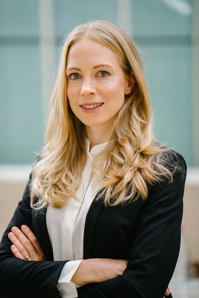 Professional head shot of a Caucasian white woman in a suit. She is smiling and appears confident and relaxed. She is a professional (banker, lawyer, founder) and is dressed up to pursue her career. - Fotó, kép