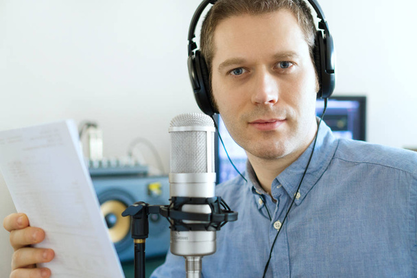 Handsome man recording an advertisement on the radio station. - Photo, Image