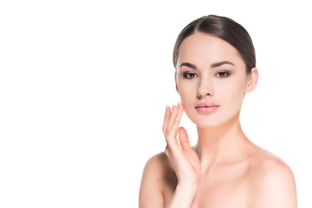 beautiful young woman applying moisturizing cream on face isolated on white - Foto, Bild