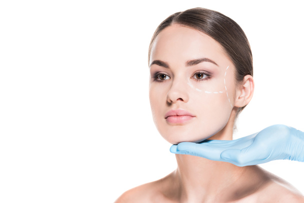doctor touching face of beautiful woman with dotted line for plastic surgery isolated on white - Photo, Image