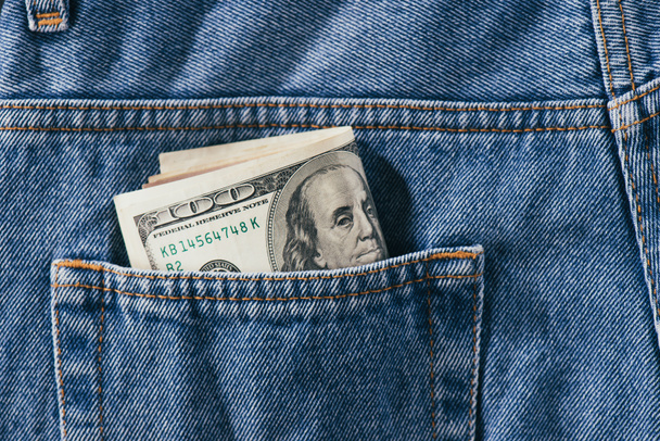 close up view of dollars banknotes in jeans pocket - Φωτογραφία, εικόνα