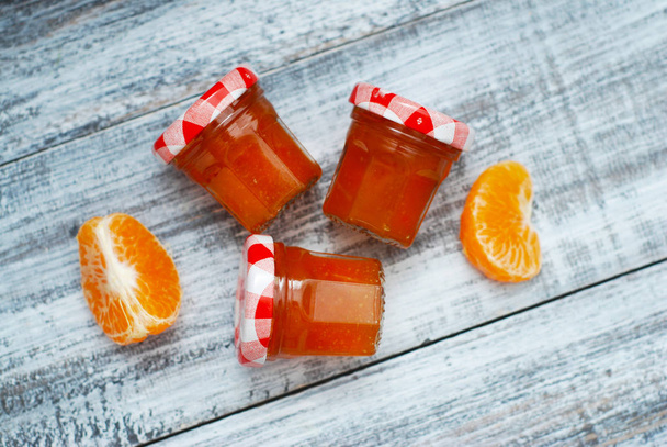 Orange Jam in Glass Jar on Gray Wooden Background. Fruit Jam with Citrus Fruits. Rustic Homemade Sweet Jam. - Photo, image