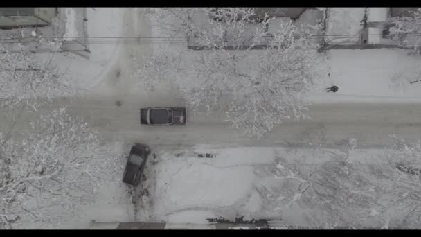 Aerial footage of car riding on winter road - Filmati, video
