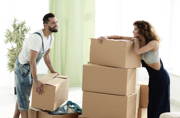 young couple unpacking boxes in a new house - Foto, imagen