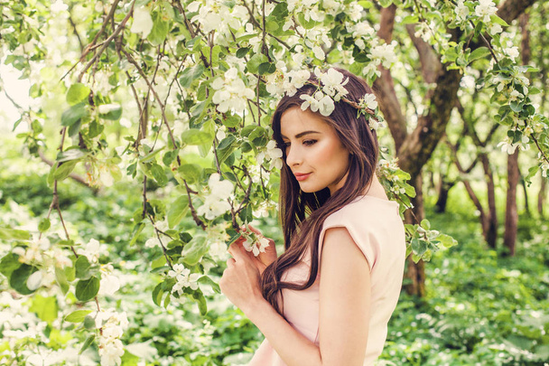 Beautiful young female model on blossom spring flowers garden  - Fotoğraf, Görsel