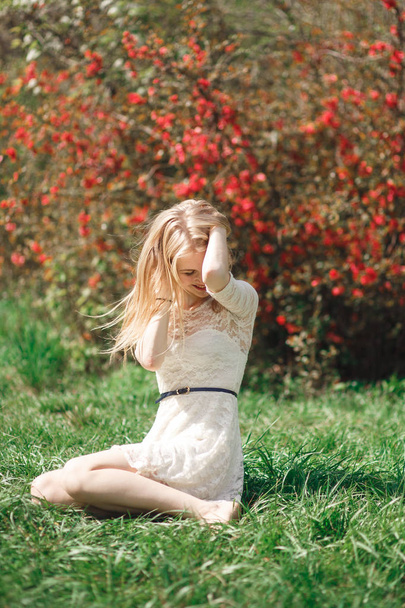 Beautiful young woman enjoying sunny day in park during blossom season on a nice spring day. - Φωτογραφία, εικόνα