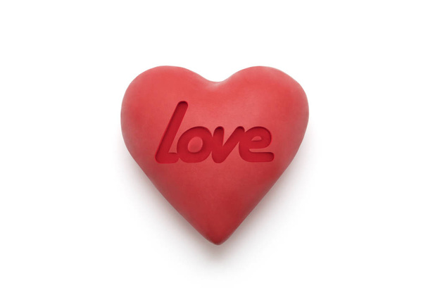 Красное сердце с запечатленным любовным словом на белом фоне с вырезкой пути
  - Фото, изображение