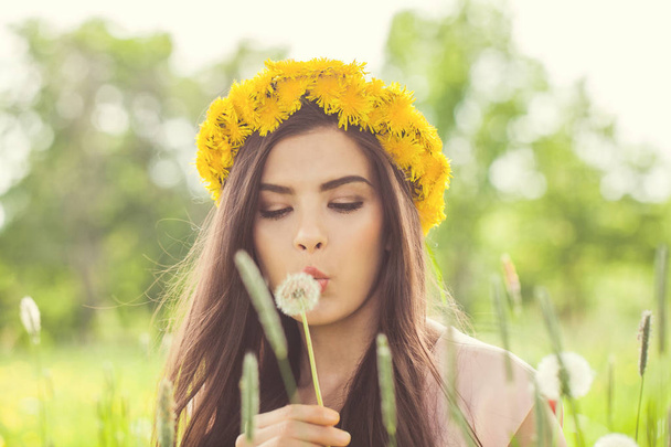 Summer woman blowing on dandelion flowers - Photo, Image
