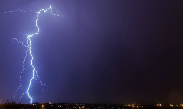 Large Lightning Strike to ground - Cloud to ground lightning strike over Johannesburg at night time. This region of South Africa receives annual summer thunderstorms - Photo, Image