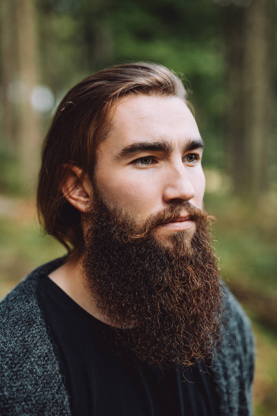 Portrait of a bearded boy in the woods - Photo, Image