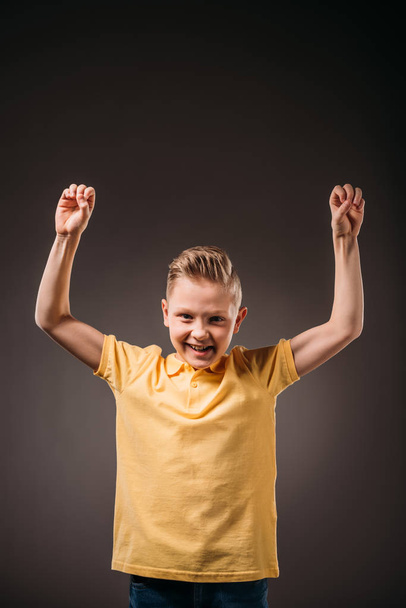 preteen smiling boy gesturing, isolated on grey - Foto, afbeelding
