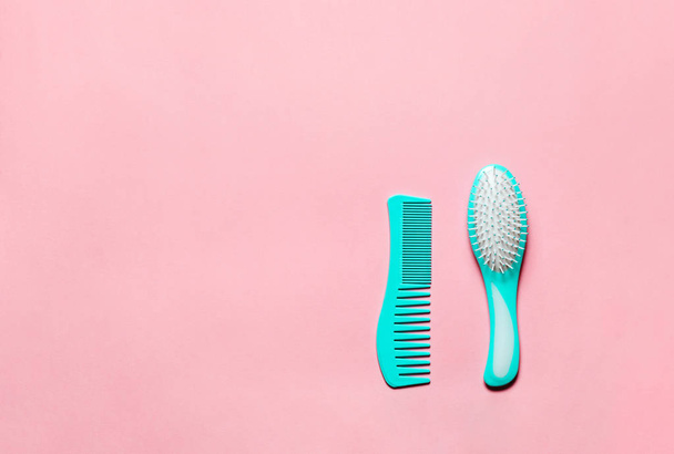 Two Turquoise hair comb crest brushes with handle for all  types, isolated on pink copy space background. Mininmalistic feminine flat lay. - Фото, изображение