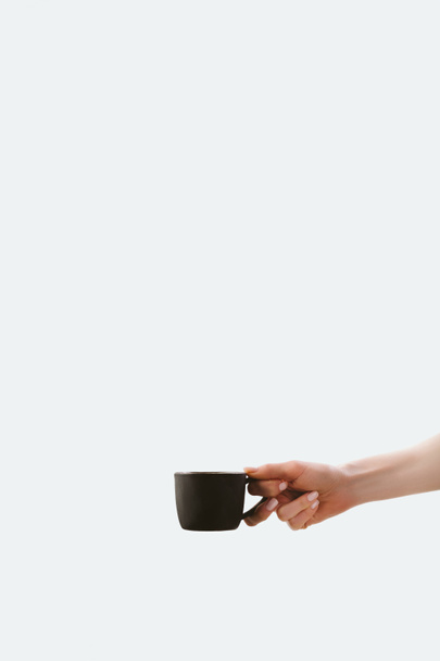 cropped view of hand holding cup of morning coffee, isolated on white - Fotografie, Obrázek