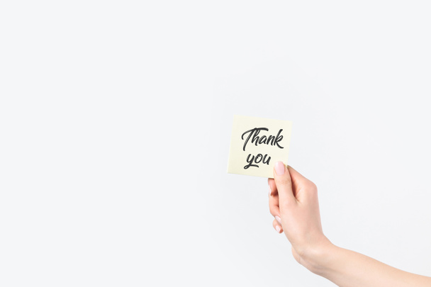 partial view of woman holding thank you card isolated on white - Фото, изображение