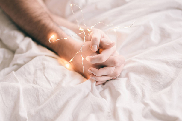 hands of lovers on the bed - Fotografie, Obrázek