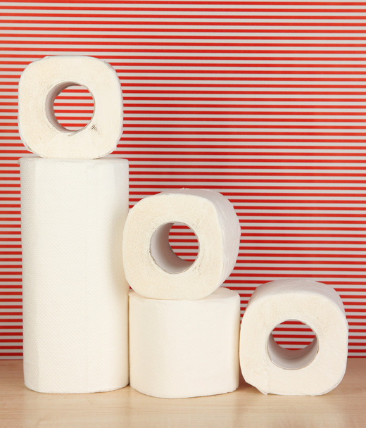 Rolls of toilet paper on striped red background - Φωτογραφία, εικόνα