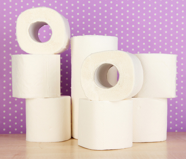Rolls of toilet paper on purple with dots background - Fotó, kép