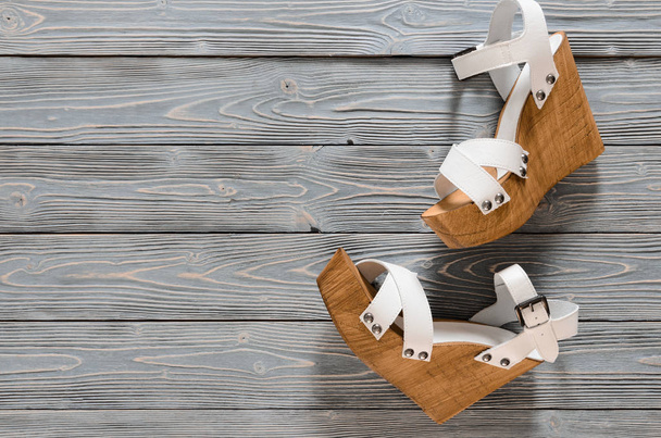 Womens shoes (crisscross wood platform wedges) on grey wooden ba - Photo, Image