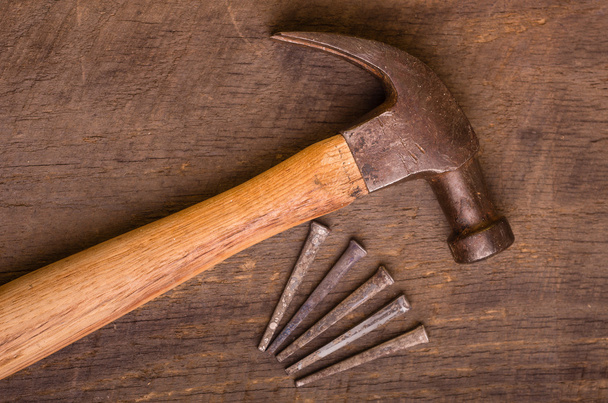 Hammer and nails on a wood board - Photo, Image