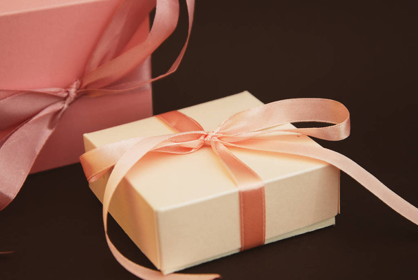 Close up Gift Box with a pink bow Isolated on Brown Background. Gift, birthday. Sale Concept. Copy space for Text. - Valokuva, kuva