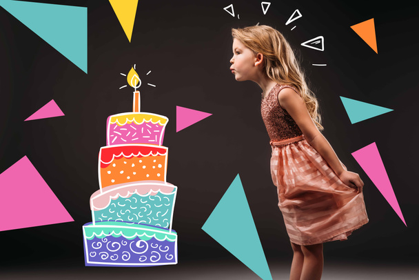 pretty child in pink dress blowing drawn candle on birthday cake, isolated on grey - Фото, зображення