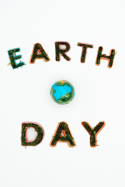 top view of earth model with text earth day isolated on white - Foto, immagini