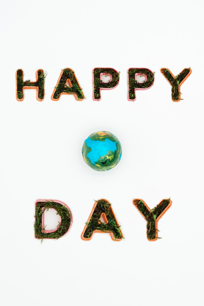 top view of earth model with text happy earth day isolated on white - Photo, Image