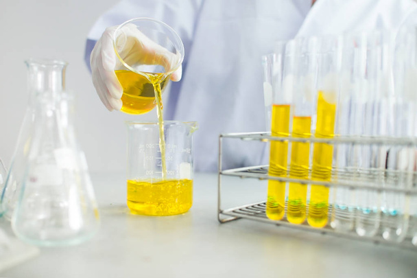 Oil pouring, Formulating the chemical for medicine,Laboratory research, dropping liquid to test tube - Фото, зображення