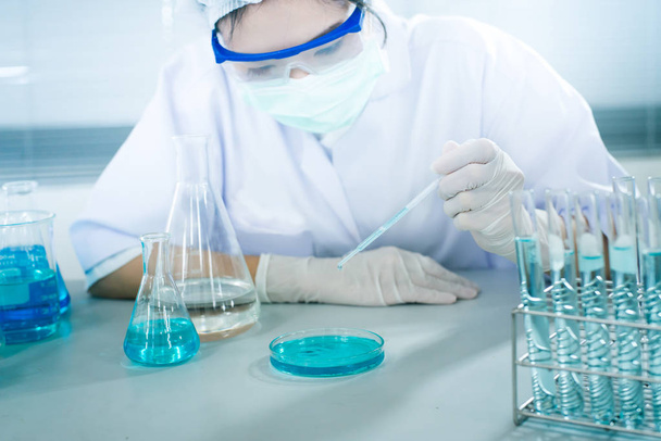 Female scientist analyzing sample in laboratory - Фото, зображення