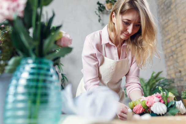 Photo of florist making bouquet at table - Photo, image