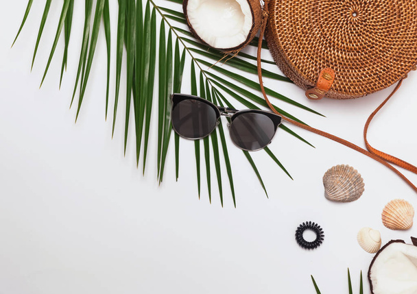 Feminine accessories, greem leaves and half of the coconut. - Φωτογραφία, εικόνα