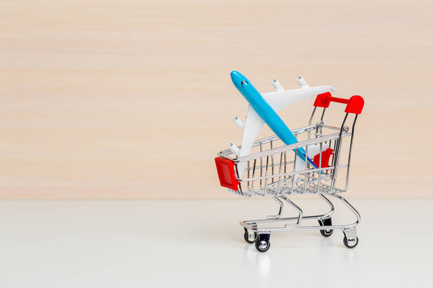 Shopping trolley on wooden background - Фото, изображение